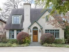 a house that has some bushes in front of it