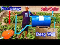 a man standing in front of a blue barrel with water coming out of it and the words, free energy auto water deep well