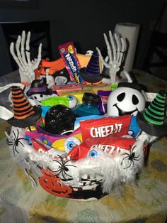 a table topped with lots of halloween decorations and candy bags on top of it's head