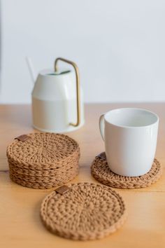 the coasters are made out of jute and have coffee cups on them, along with a tea pot