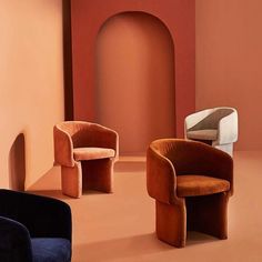 two chairs sitting next to each other in front of a wall with an arched doorway