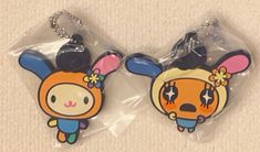 two key chains with cartoon characters on them