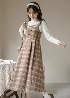 Tweed plaid pinafore dress with flutter straps, little bows down the chest and a midi skirt. Concealed back zipper. S: 33" chest, 26.5" waist, 42" lengthM: 34.5" chest, 28" waist, 42" lengthL: 36" chest, 29.5" waist, 42.5" lengthXL: 37.5" chest, 31" waist, 42.5" length Brown Plaid Dress, Plaid Outfits, Church Outfits, Pinafore Dress, Brown Plaid, Brown Dress, Overall Dress, Plaid Dress, Dress With Cardigan