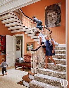 three children are climbing up the stairs in this house