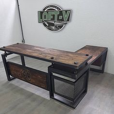 a wooden table sitting on top of a hard wood floor next to a white wall