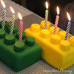 there are many candles that are on the birthday cake with green and yellow icing