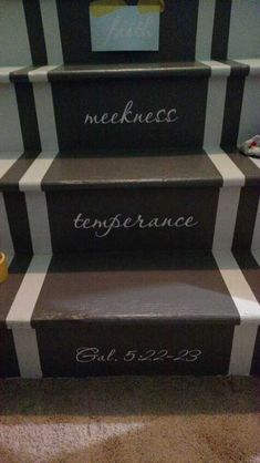 some stairs with writing on them that are painted black, white and grey striped carpet