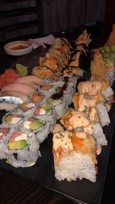 there are many different types of sushi on the table