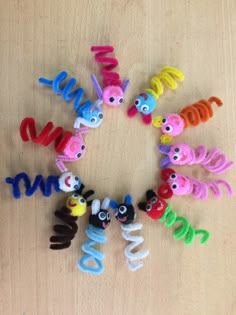 a group of toy animals sitting in the middle of a circle on top of a wooden table