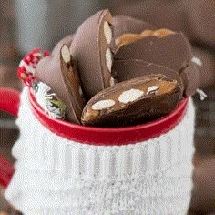 some chocolates are in a red and white cup