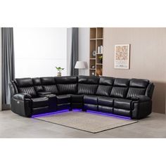 a black leather sectional sofa with blue lights on the bottom and back ends, in front of a beige rug