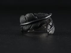 The Raven Feather Ring by Lost Apostle Luxe. Hand carved and cast in Sterling silver, with an oxidized finish and burnished details at the tip of the feather and at the quill.  The ring is extremely comfortable to wear with a high polish finish on the inside of the band.  Please indicate your size from the menu - the ring by design can be adjusted to ensure a perfect fit. Silver Feather Jewelry, Raven Ring For Men, Raven Rings, Oc Details, Crow Ring, Weding Rings, Raven Ring, Beard Rings, Descendants Oc