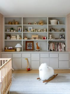 a baby's room with bookshelves and toys