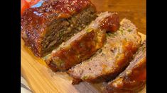 sliced meatloaf on a cutting board with ketchup