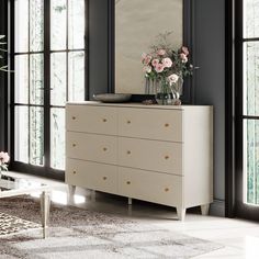 a white dresser sitting next to a window filled with flowers