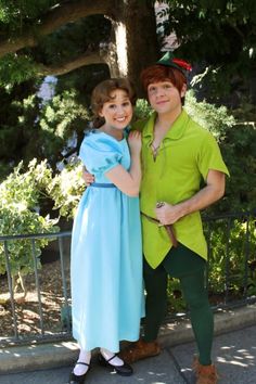 a man and woman dressed as peter panton and tinkerbell pose for the camera