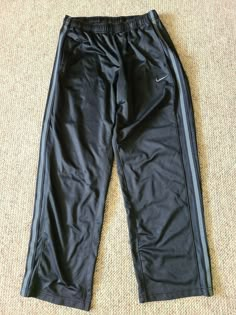 This auction is for one Men's Nike Polyester Workout Running Athletic Pants Sweatpants Color is Black Size is Large Inseam is 30 inches Waist unstreched is 14 inches. There are Two front pockets There is a Drawstring at the waist. Please check out the pictures Email any questions