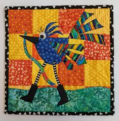 an image of a colorful bird on a patchwork background that says creating freebieric