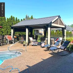 an outdoor pool with lounge chairs and a hot tub