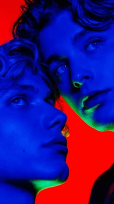 two men are looking at each other in the same direction, one is blue and the other is red