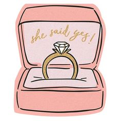 a pink box with a gold ring inside that says she said i'm getting married