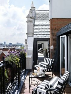 the balcony is decorated with black and white furniture