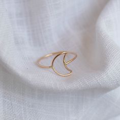 Selene, featuring the crescent moon shaped into a ring and wrapped around your finger. - Made with 14k gold filled or sterling silver material - 1mm round band, 9x12mm crescent moon You may experience a slight color difference in places where the metal has been soldered making every piece truly unique. If you do not see your size, please reach out to us by email at info@hellorising.com. We believe that everyone deserves to wear beautiful jewelry. Purchase three or more rings and save 15% with di Moon Minimalist, Crescent Moon Ring, Gold Stacking Ring, Tiny Rings, Gold Ring Designs, Moon Ring, Gold Moon, Gold Ring Stack, Moon Shapes