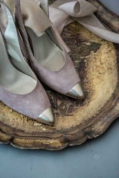 a pair of shoes sitting on top of a piece of wood