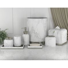 marble bathroom accessories including soap dispenser, toothbrush holder and tissue dispenser