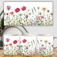 three coffee mugs with flowers painted on them