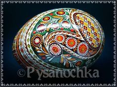 an ornate painted egg on a black background