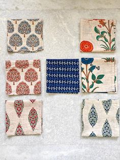 six napkins with different designs on them sitting on a counter top next to each other