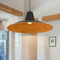 a light hanging from the ceiling in a kitchen