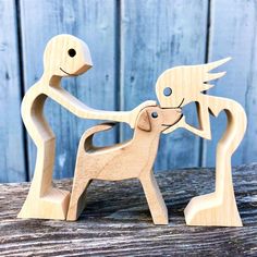 two wooden toy dogs playing with each other