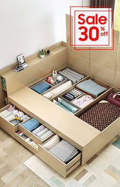 a bed with drawers and a sale sign in the background