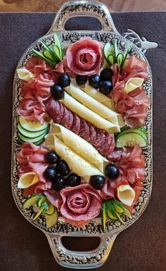 a platter filled with different types of meats and vegetables