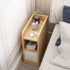 a bedside table with an alarm clock on it