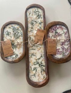 three wooden trays filled with different types of soap