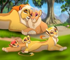 the lion family is laying down in the grass