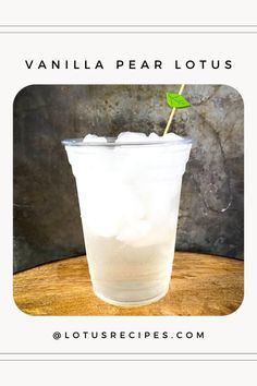 a glass filled with ice sitting on top of a wooden table