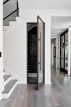 an image of a wine rack in the middle of a room with stairs leading up to it