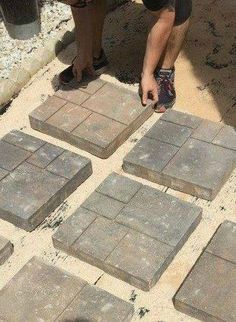 a person standing next to some bricks on the ground