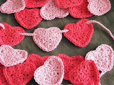 crocheted hearts laid out on a table to be used as garlands for valentine's day