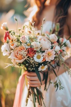 a woman holding a bouquet of flowers in her hands