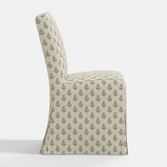 an upholstered chair with a pattern on the back and seat, in front of a white background