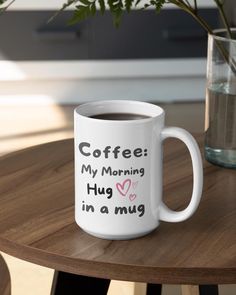 a white coffee mug sitting on top of a wooden table