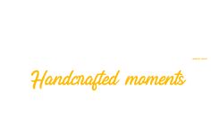 the words handcrafted moments are written in yellow on a white background with an orange border