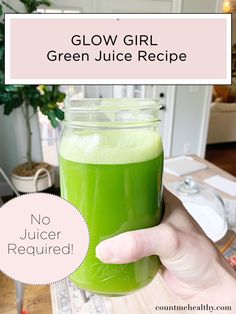 a person holding up a green juice in a mason jar with the text glow girl green juice recipe