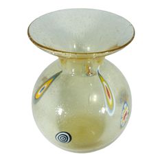 a yellow glass vase with designs on it