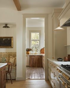 a kitchen with an oven, sink and stove top in the middle of the room